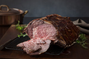 A prime rib roast beef, sliced open to show medium rare meat.  Very shallow DOF.